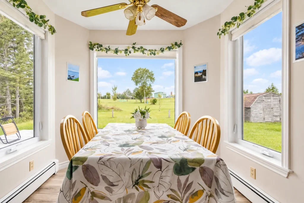 Breakfast table surrounded by garden-facing windows