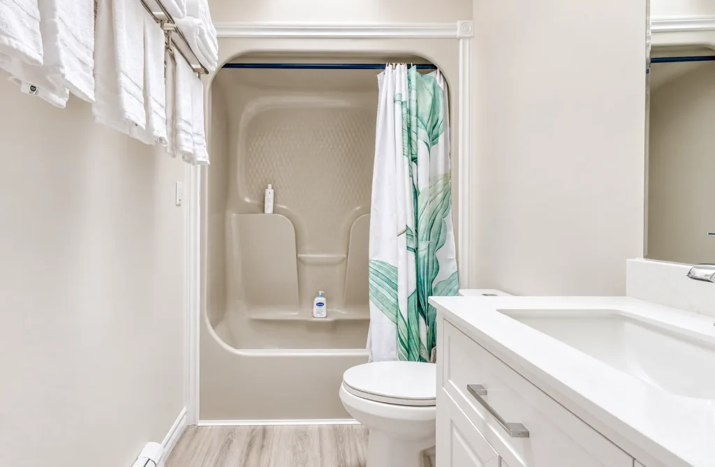 Hallway bathroom with bathtub and shower
