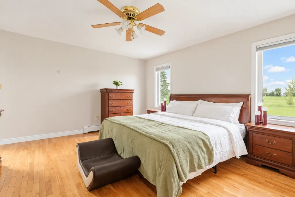 Main bedroom with bed and two windows