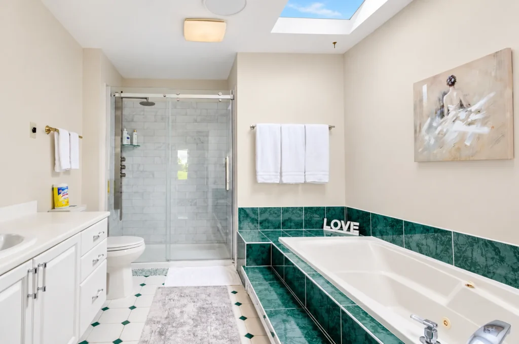 Main bathroom with bathtub and separate shower